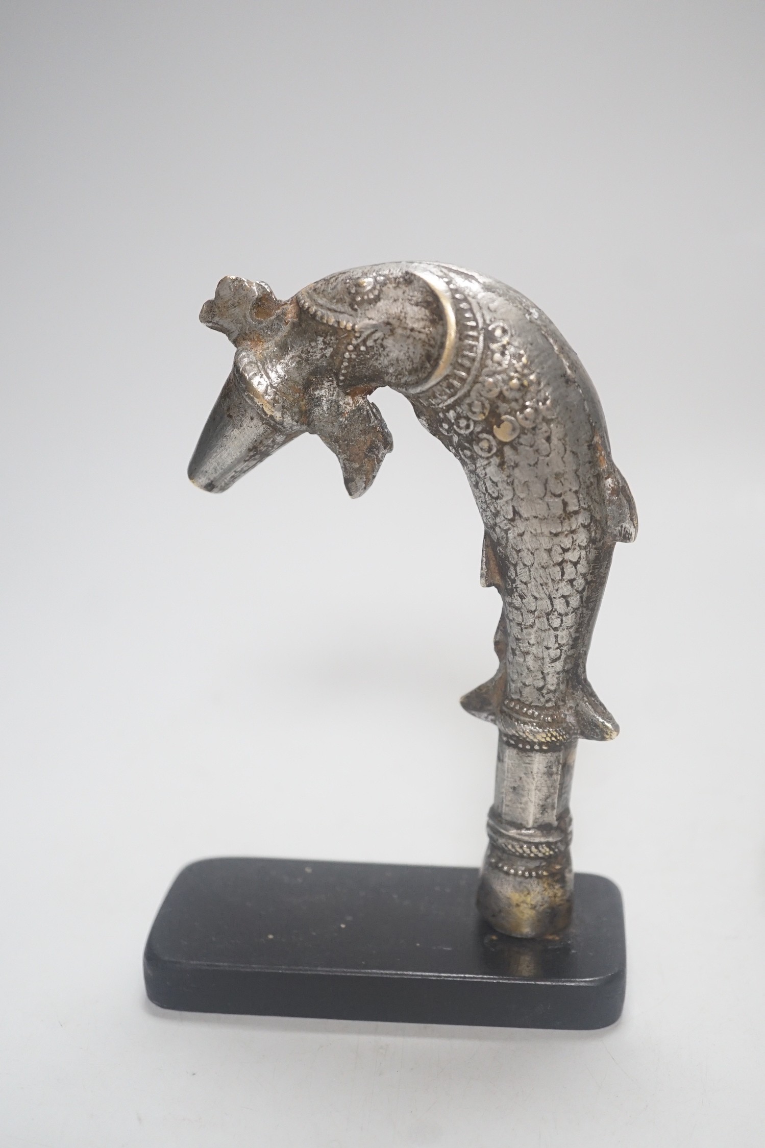 A Continental silvered and gilt metal inkwell, c.1900, and an Indo-Persian silvered bronze ‘fish’ tap or cane handle on stand, 16cm